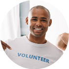 Httpselements.envato.comhappy handsome volunteers pointing at signs on t s AACZ3P4.png