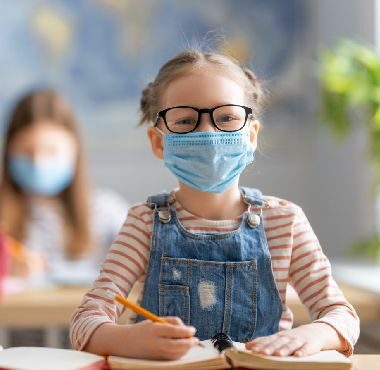 Httpselements.envato.comkids are wearing facemasks learning in class L6U24YC.jpg